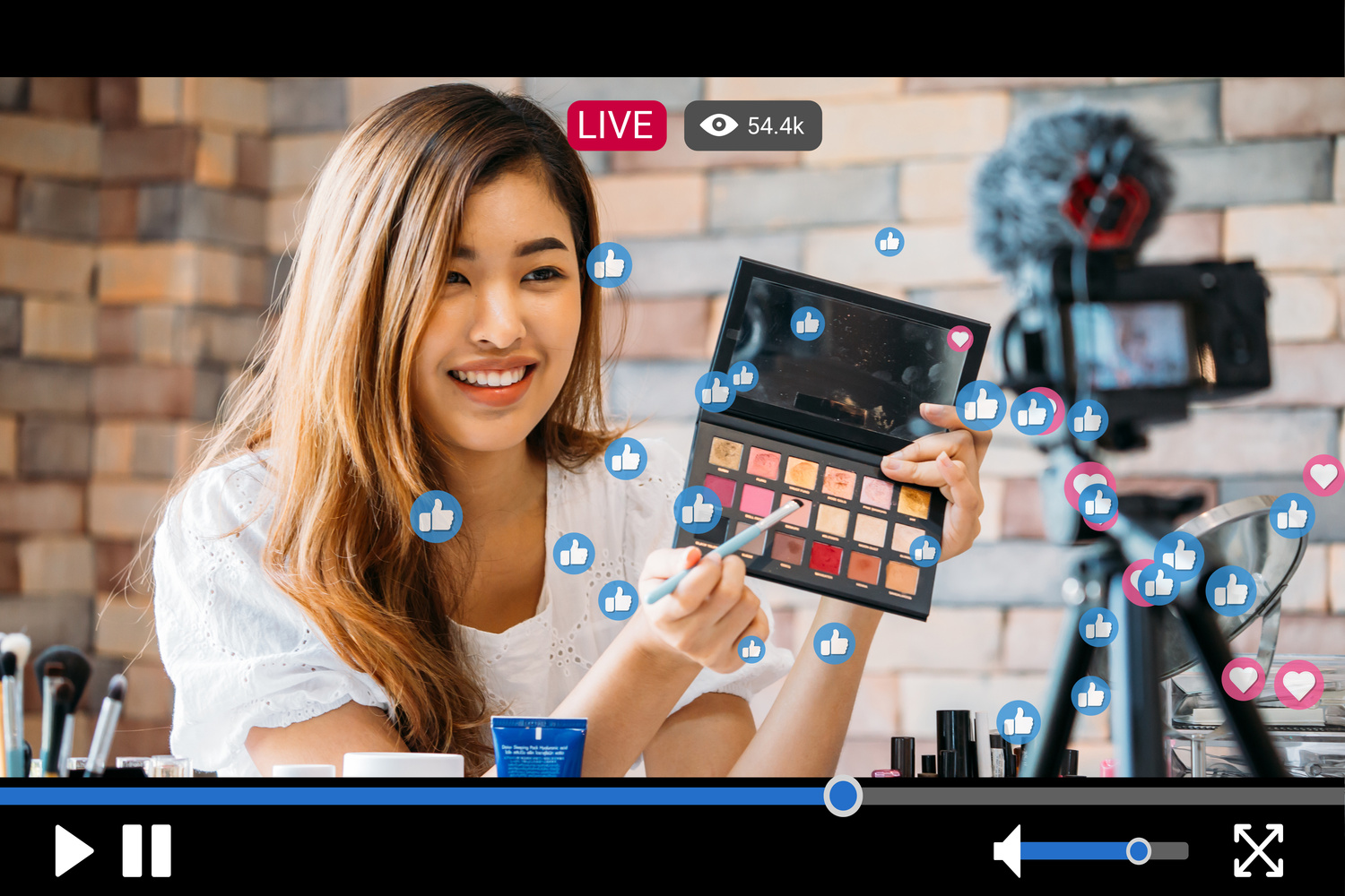 Woman Does Makeup While Recording Live Stream with Video Player